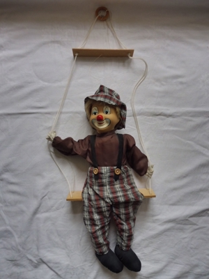 Clownfigur auf Schaukel