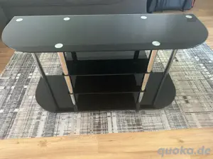 Beistelltisch aus Glas mit Metallbeinen