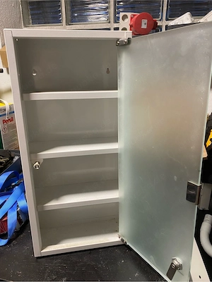 Metallschrank mit Milchglastür.