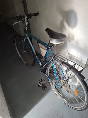 Blaues Herrenfahrrad mit Gepäckträger und Rahmentasche an Bastler