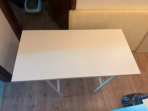 White work table with unassembled metal trestles   Good condition
